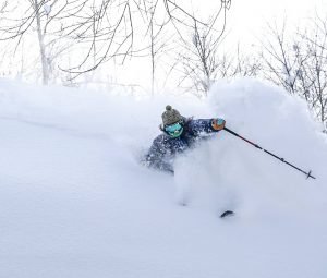 skier carving in deep powder