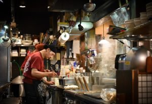 chef cooking ramen in kitchen sapporo hokkaido