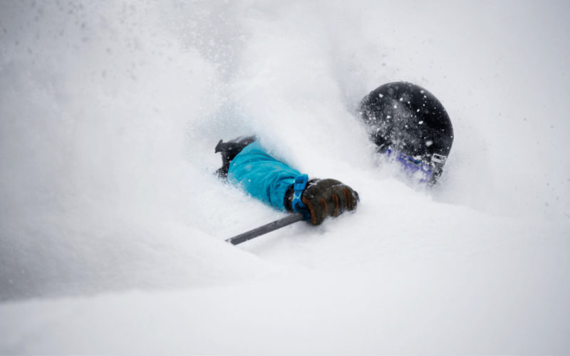 Skier at Kiroro resort who is barely visible because they are covered in the deep powder