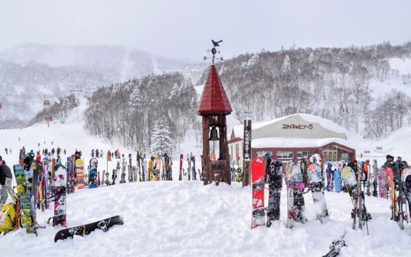 The base of Sapporo Kokusai with crowded ski racks